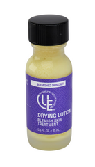 1 /2 oz. glass bottle of Uniquely Effective Skincare’s Drying Lotion with visible with natural elements like propolis, sulfur, and horsetail emphasizing its potent, two-phase treatment for calming whiteheads and soothing inflamed skin.