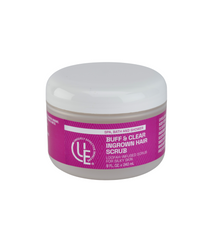 Buff & Clear Exfoliator for Ingrown Hairs in an 8 fl. oz. jar shown on a spa-like surface with natural loofah and plant elements to reflect its exfoliating and nourishing properties.