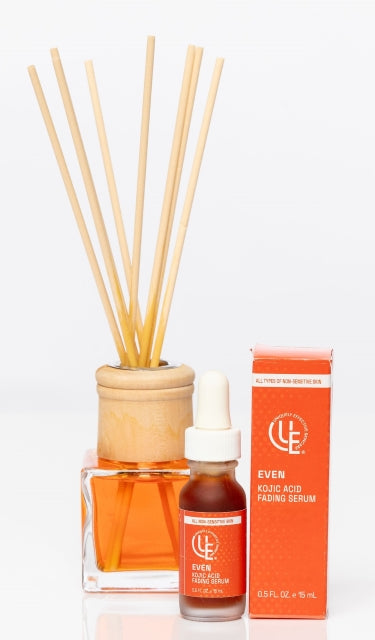 1 /2 oz. dropper bottle of Uniquely Effective Skincare's Even Kojic Acid Fading Serum positioned next to diffuser symbolizing clarity and renewal for oily and uneven skin types.