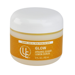 A 2 oz.  jar of Glow Organic Sugar Lemon Scrub, showcasing sugar crystals and citrus-infused formula that is designed to gently exfoliate and brighten skin for a smoother, radiant finish.
