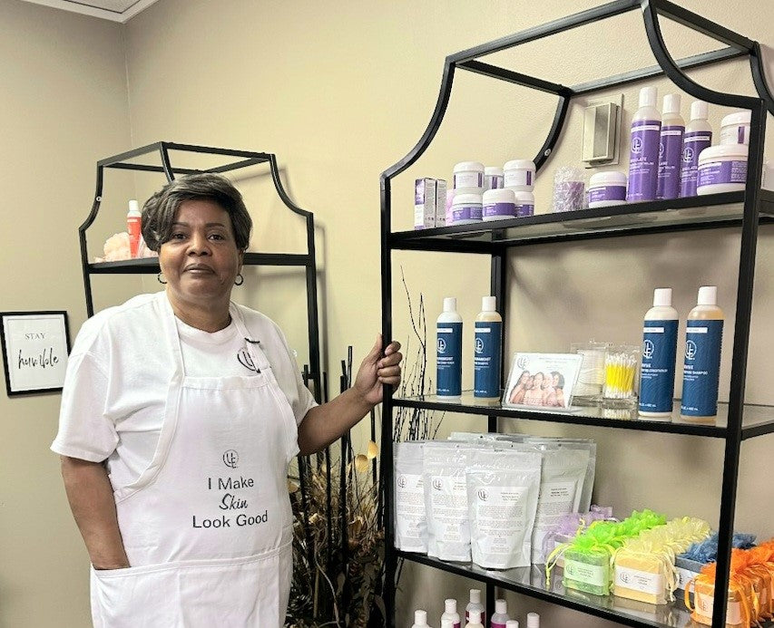 picture of owner of Uniquely Effective Skincare standing by her skincare products