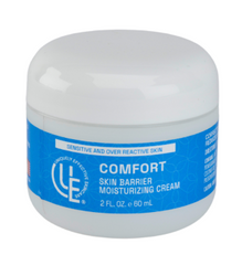 2 oz. jar of Uniquely Effective Skincare’s Comfort Skin Barrier Moisturizing Cream with fresh botanicals and probiotic highlighting its soothing, barrier-strengthening formula for sensitive and irritated skin